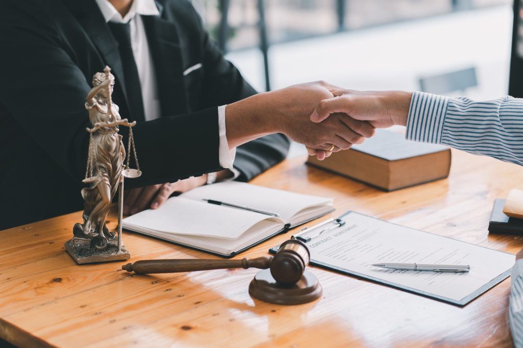 Handshake after good cooperation, Consultation between a male lawyer and businessman customer, tax